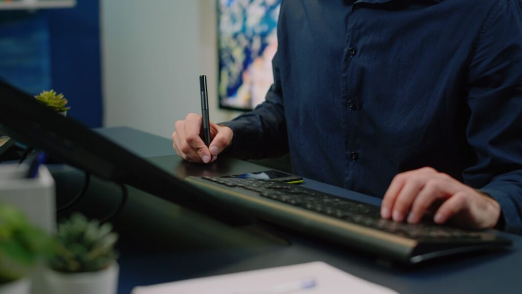 Close up of man using graphic tablet