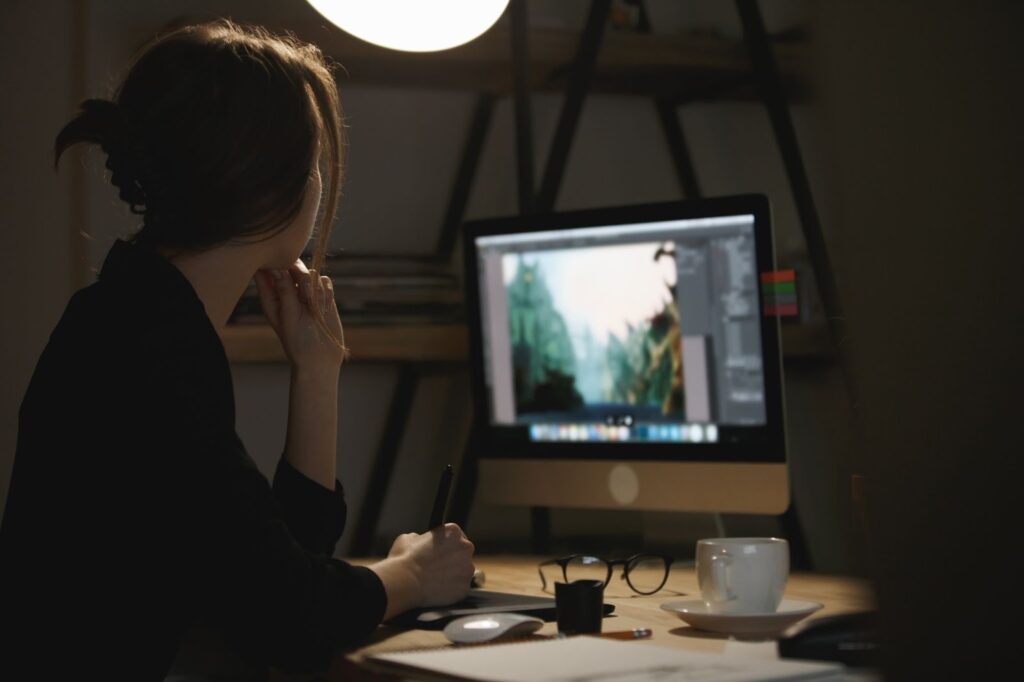 Lady designer using computer at night