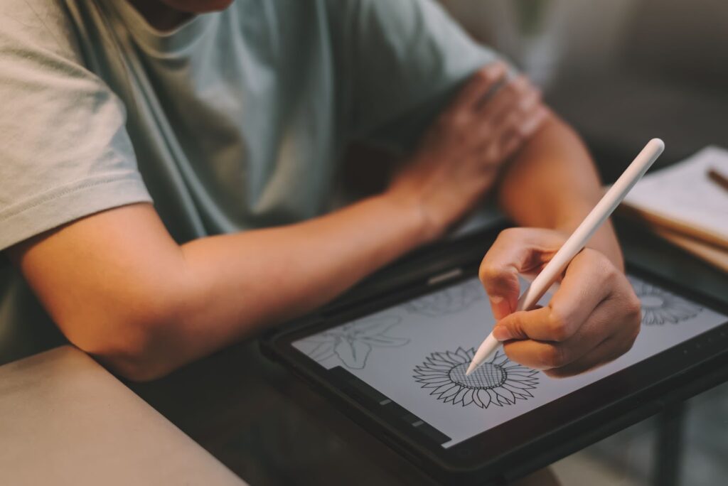 Close up of woman using tablet for drawing